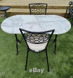 Cast iron oval shaped bistro table with marble top